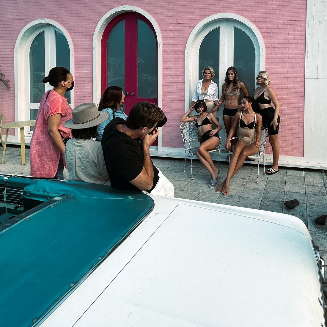 Behind the scenes photoshoot with a photographer and 5 shapewear models