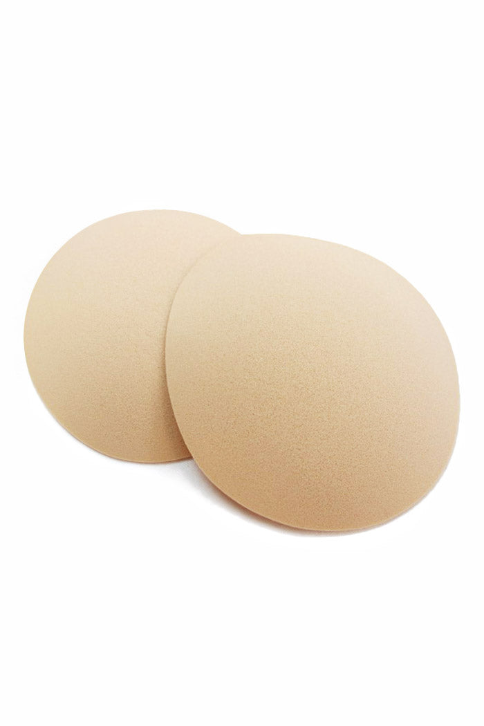 Beige foam round butt pads on a white background