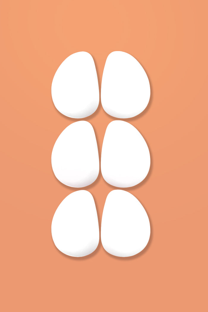 3 pair of white foam oblong-shaped pads for padding the hips or butt.